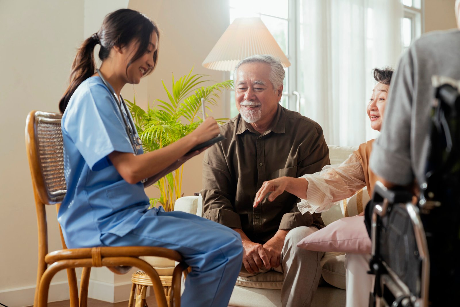 Caregiver assisting a resident with organized assisted living care records